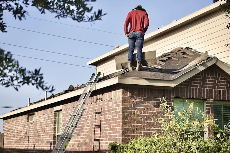 Professional roofer working on a residential roof in Zoar